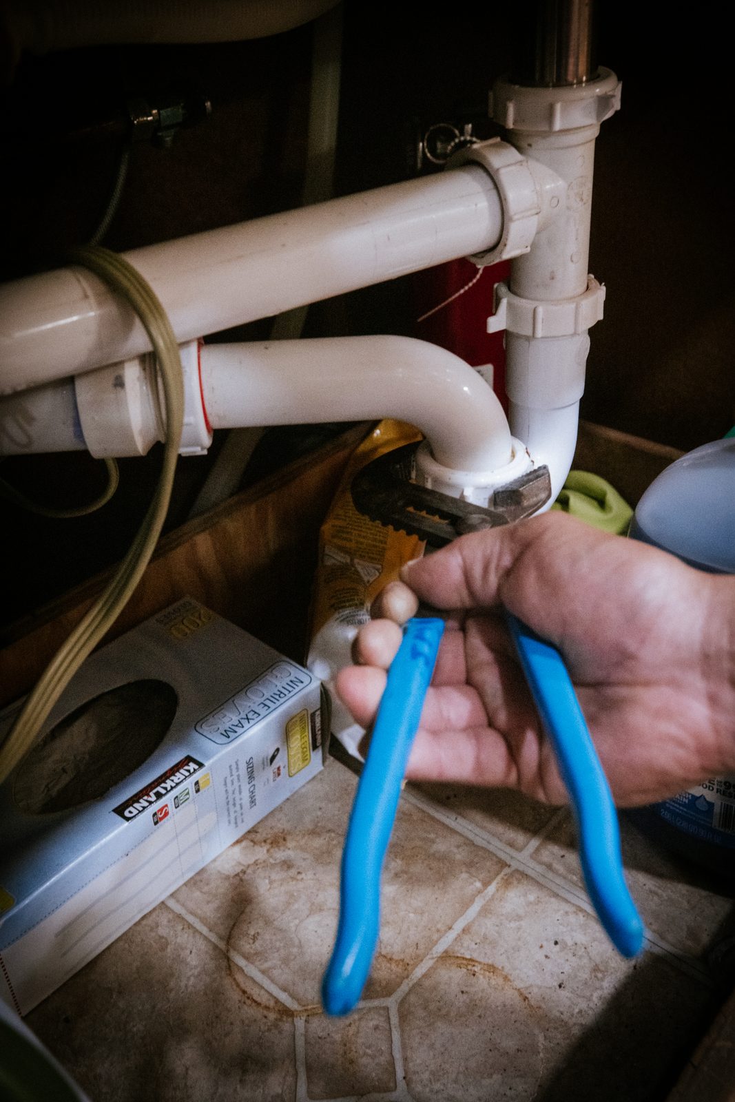 Tioga Plumbing technician clearing a blocked toilet during an after-hours emergency call in Hurst, TX