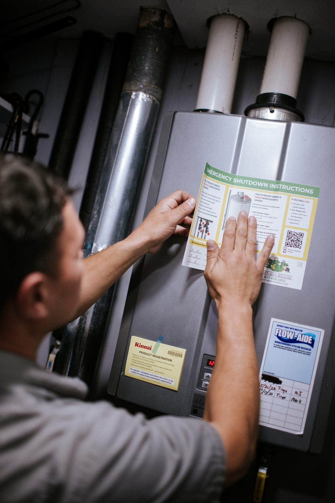Tioga Plumbing technician servicing a residential tank water heater in Hurst, TX