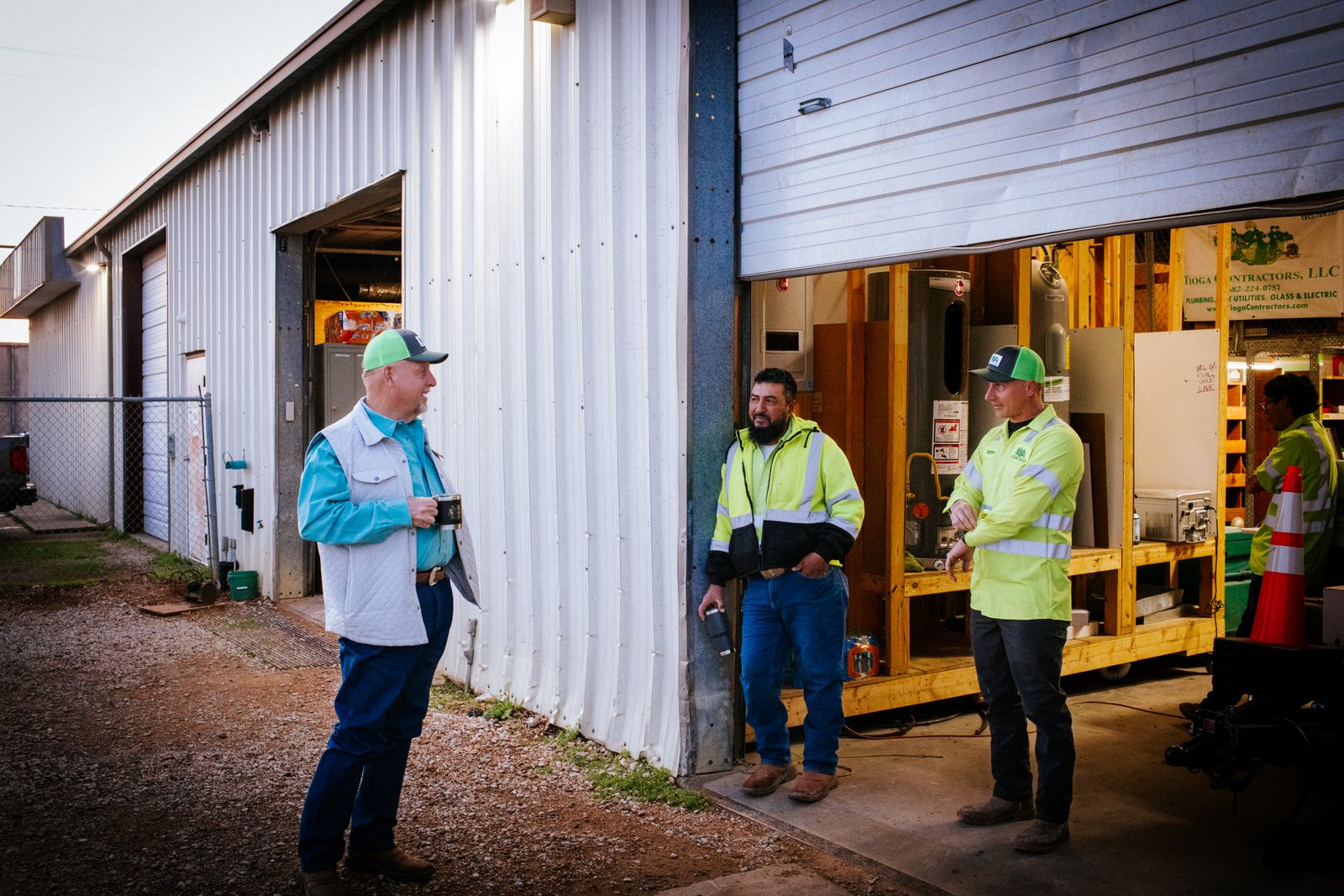 Tioga Plumbing team members at the shop bay door before the morning dispatch