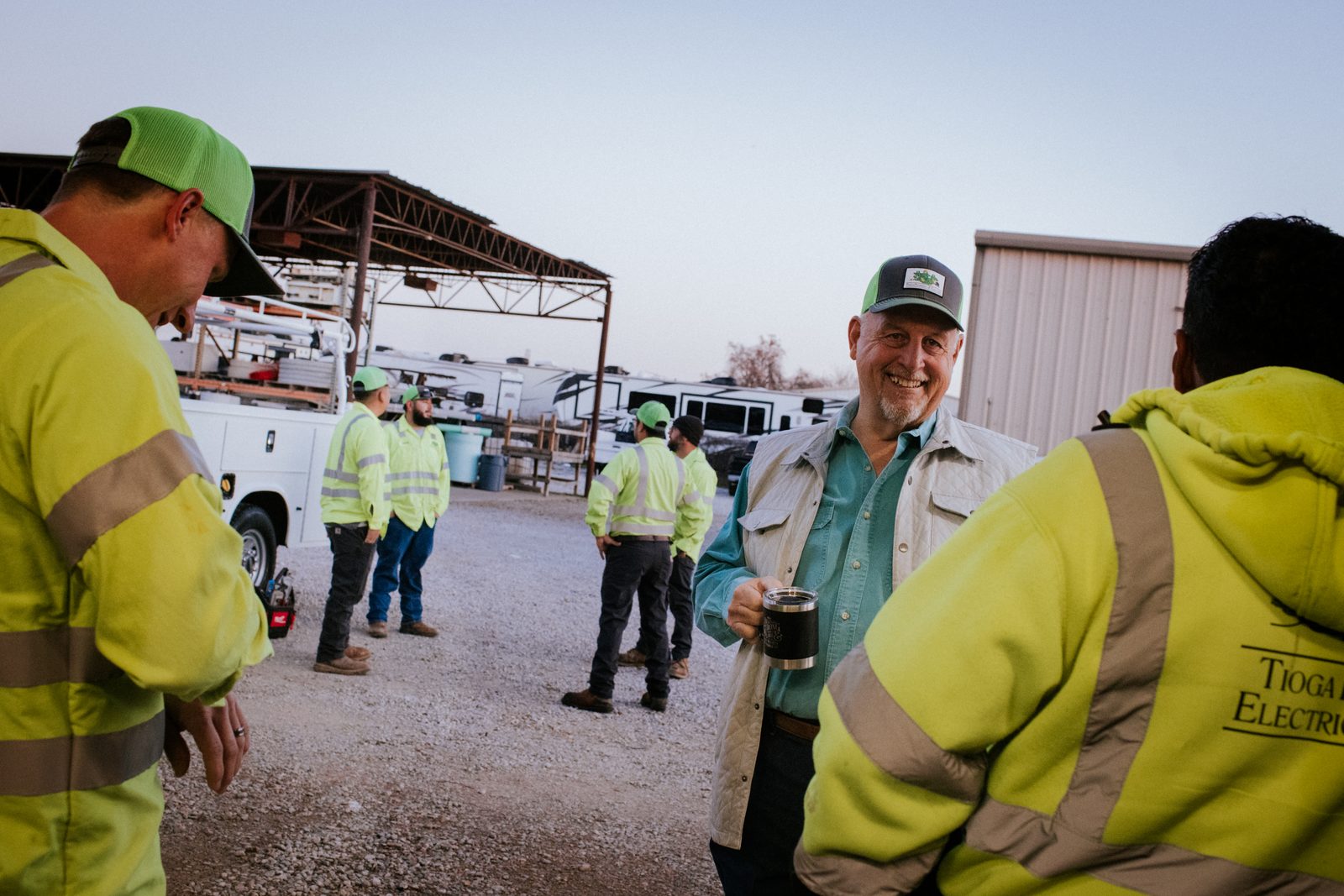 Tioga Plumbing crew talking in the Hurst yard at dusk