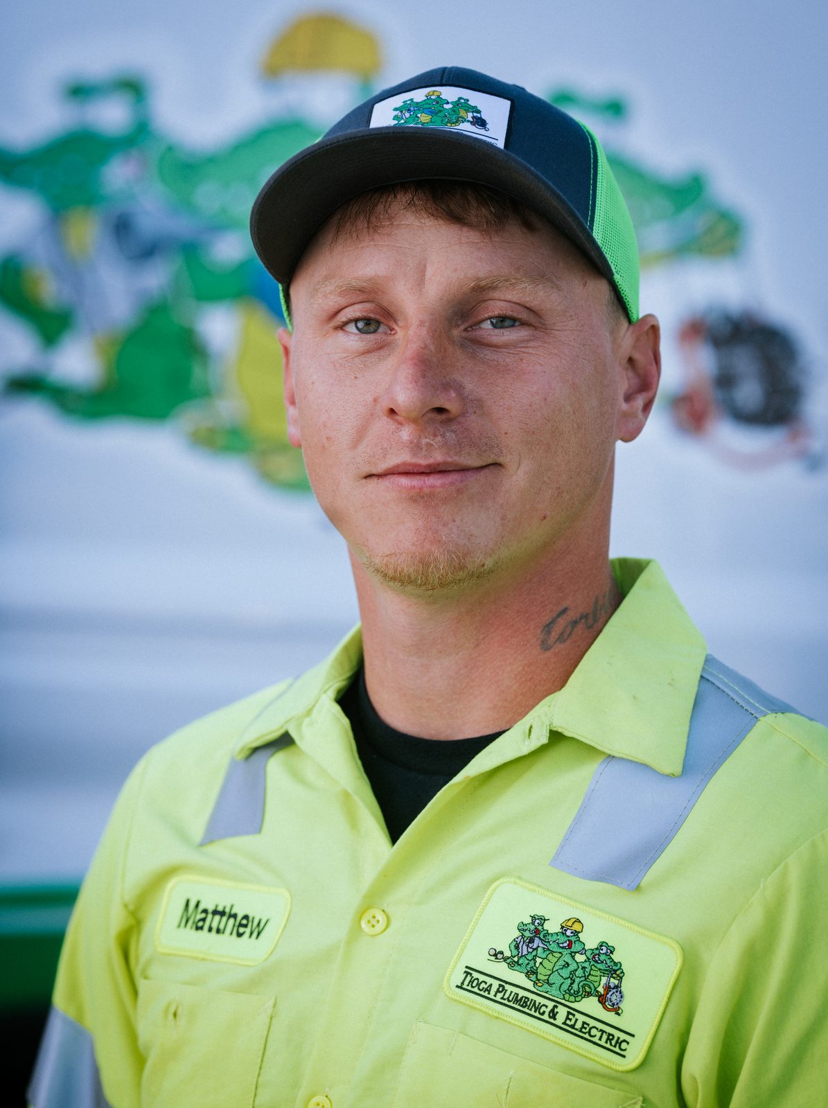 Tioga Plumbing technician Matthew, portrait in front of the gator van