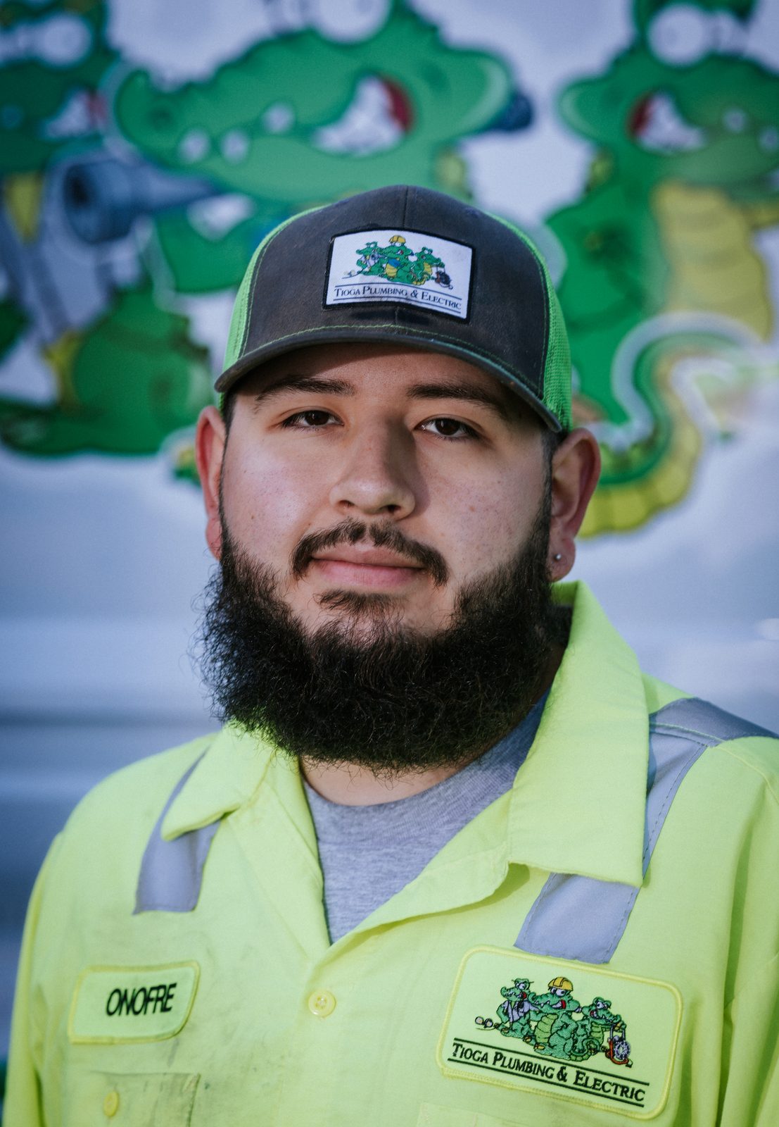 Tioga Plumbing technician Onofre, portrait in front of the gator van