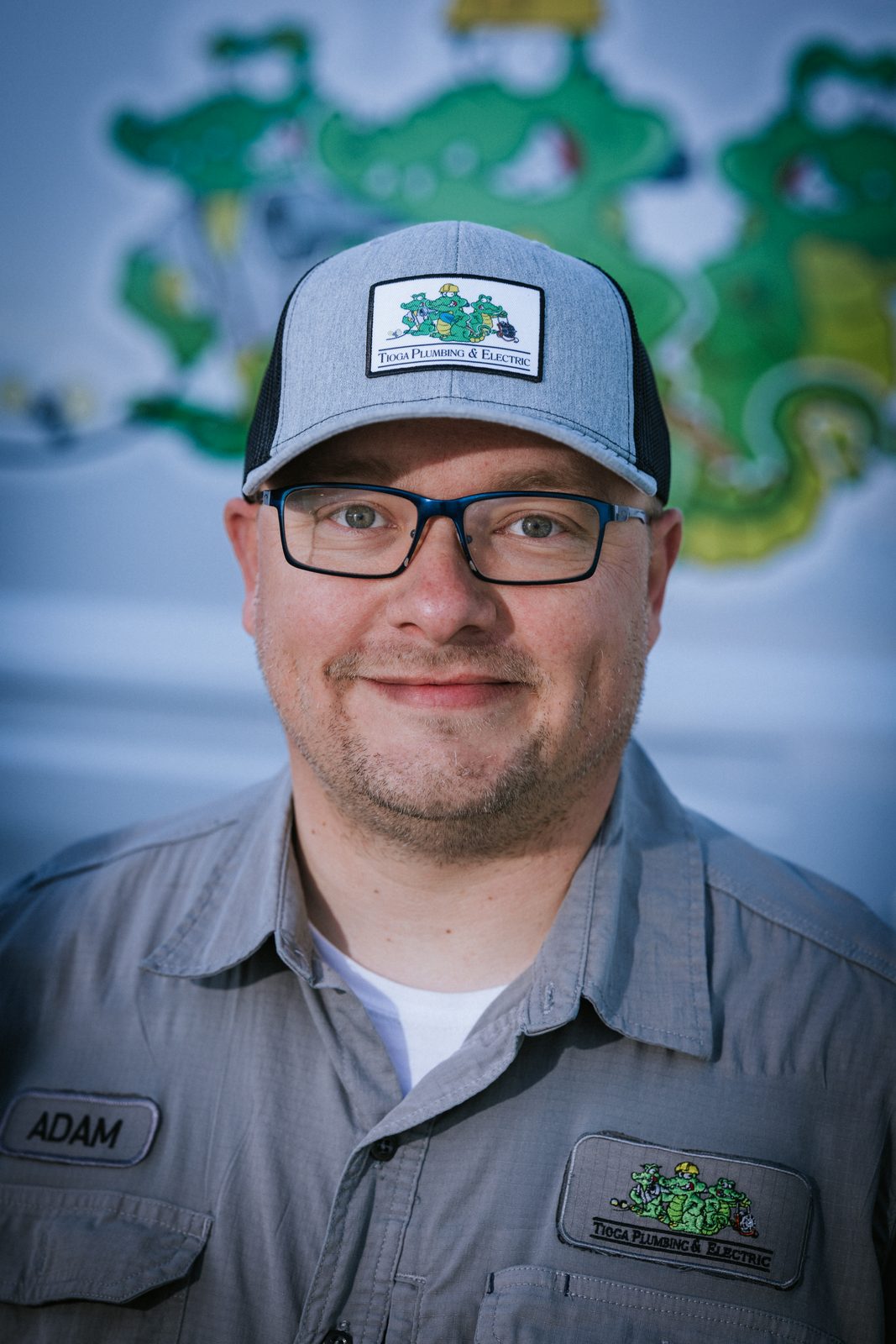 Tioga Plumbing technician Adam, portrait in front of the gator van