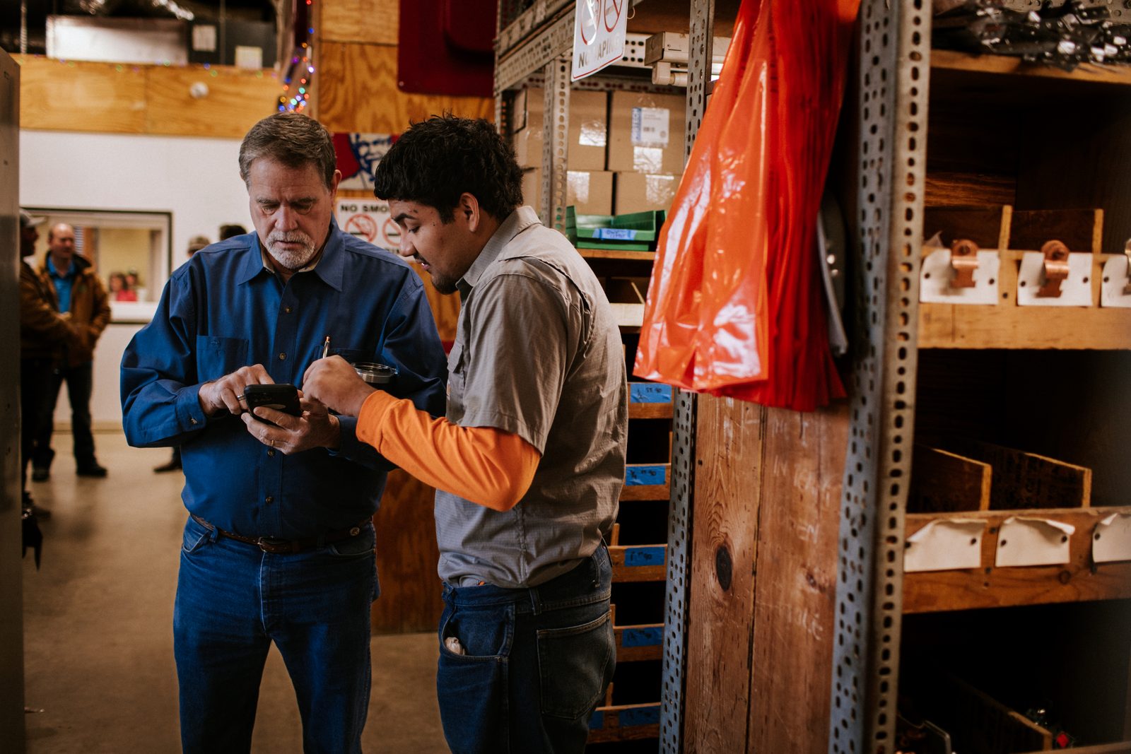 Tioga Plumbing team members checking stock in the parts room