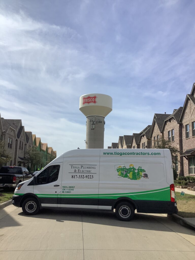 A Tioga service van in a Frisco Texas neighborhood in front of a Frisco water tower
