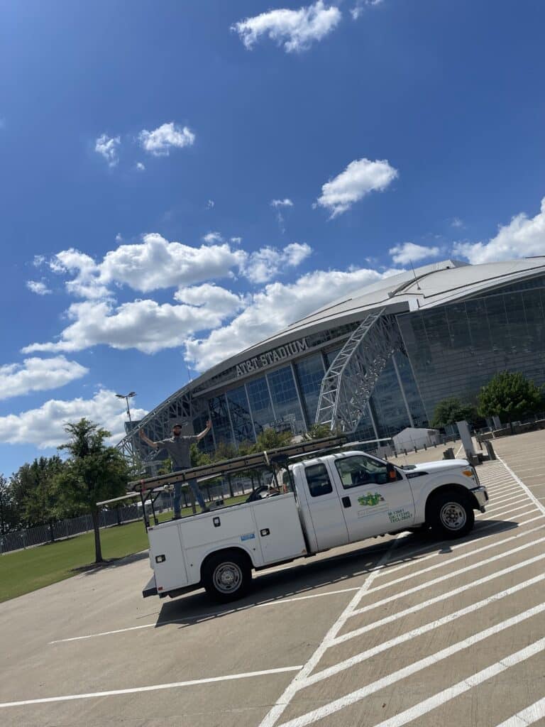 A Tioga Plumbing & Electric tech with his truck at the AT&T Stadium in Arlington Texas