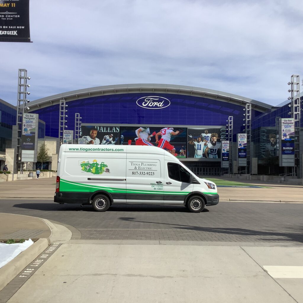 A Tioga Plumbing & Electric van at the Ford Center The Star in Frisco Texas