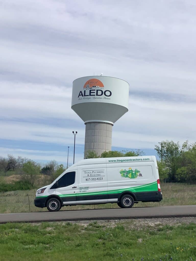 One of the Tioga Plumbing & Electric vans in Aledo Texas in front of the Aledo Water Tower