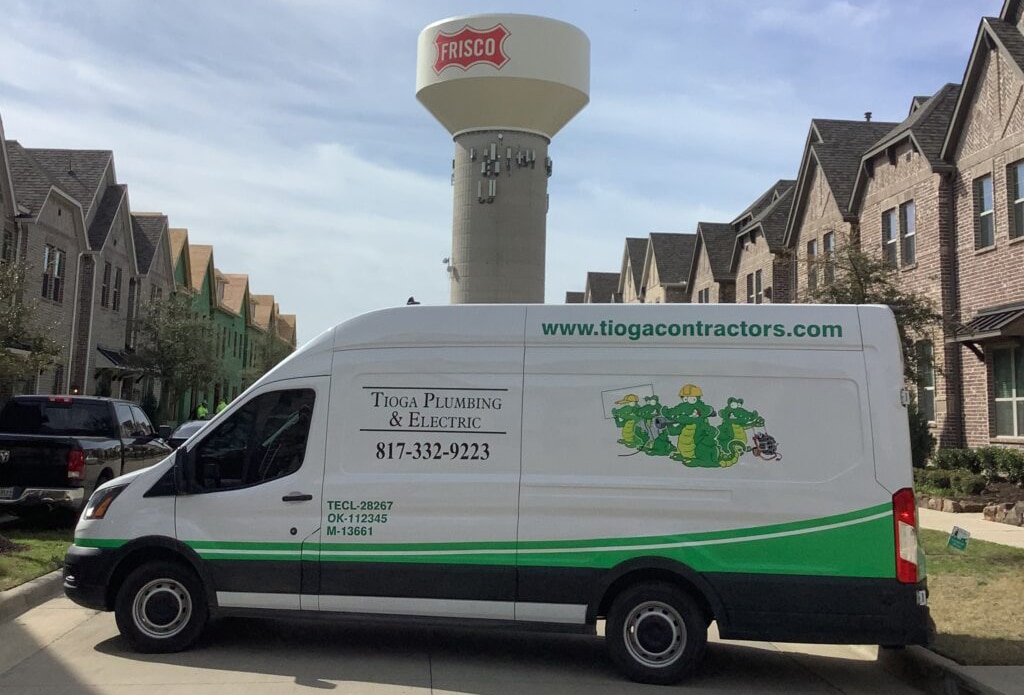 Tioga van parked in neighborhood street with the Frisco water tower in background | Tioga Plumbing & Electric serving the Frisco, TX and surrounding areas.