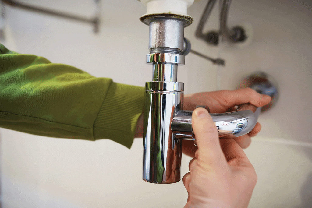 mans hand tightening up pipe water filtration system arlington tx grapevine tx 